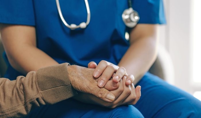 Female nurse holding her senior patient's hand. Giving Support. Female carer holding hands of senior man. holding hands with patients with love, care, help, encouragement, and empathy. healthcare.